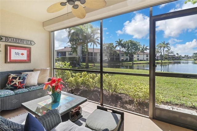 sunroom featuring a water view, ceiling fan, and a healthy amount of sunlight