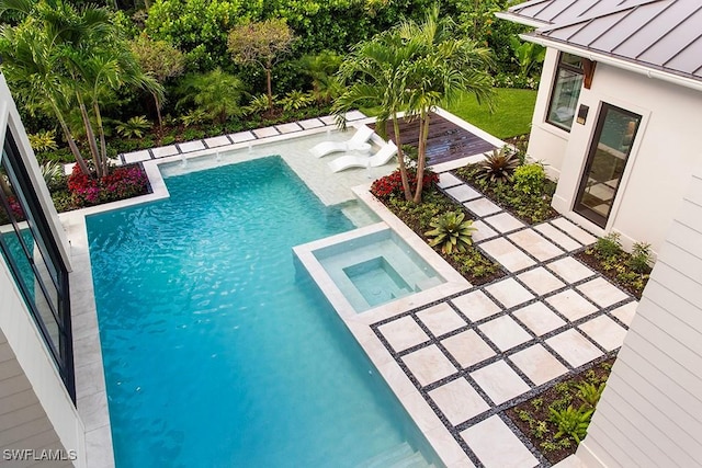 view of swimming pool featuring an in ground hot tub