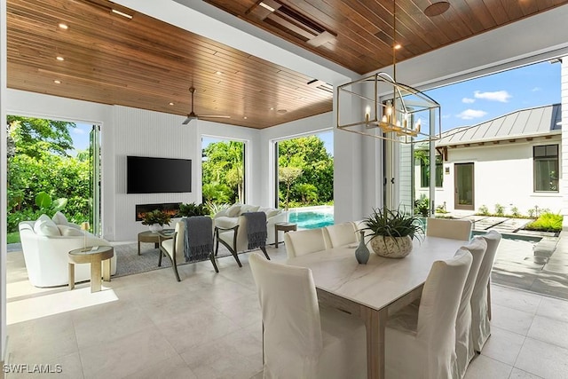 view of patio / terrace with an outdoor living space with a fireplace and ceiling fan