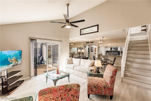 living room with ceiling fan and vaulted ceiling