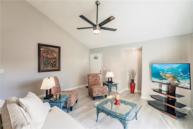 living room featuring ceiling fan, light hardwood / wood-style floors, and vaulted ceiling