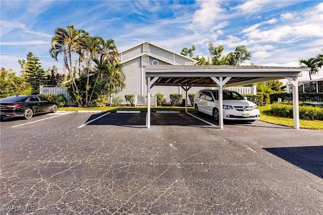 view of parking / parking lot featuring a carport