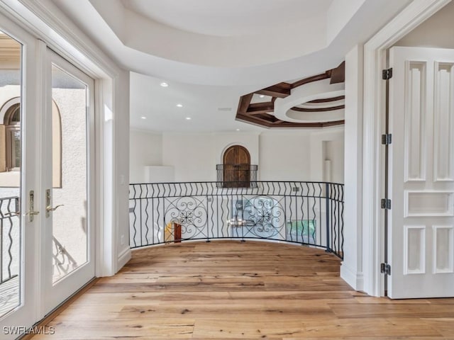 interior space with wood finished floors, coffered ceiling, beam ceiling, recessed lighting, and french doors