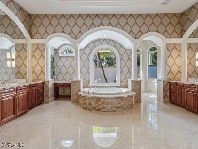 bathroom with marble finish floor, wallpapered walls, and ornate columns