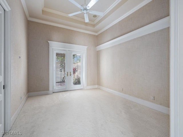 carpeted empty room with baseboards, wallpapered walls, ceiling fan, ornamental molding, and french doors