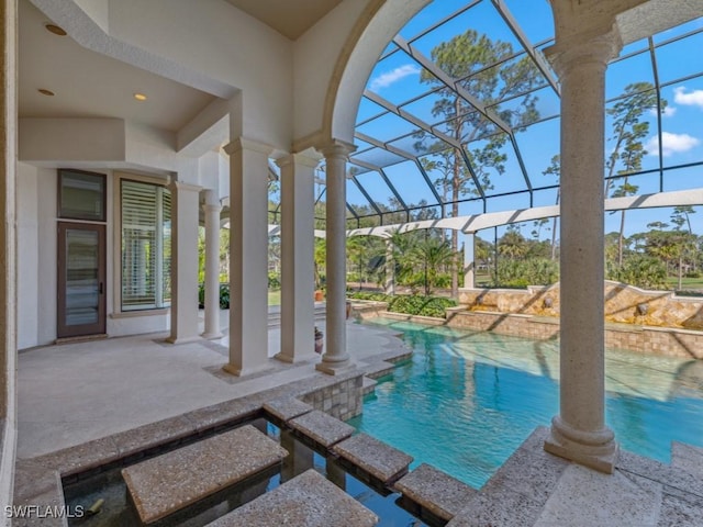 view of pool with a pool with connected hot tub, a lanai, and a patio area