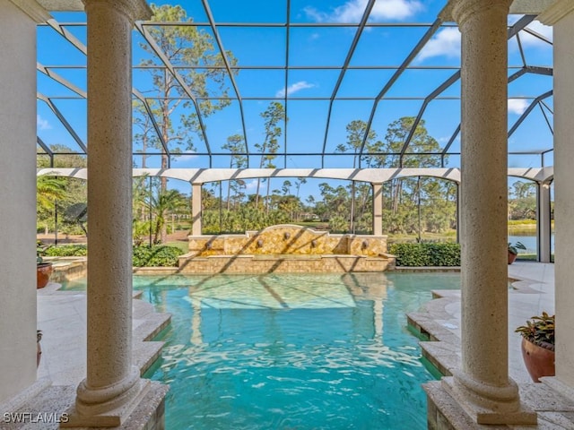 outdoor pool with glass enclosure and a patio area