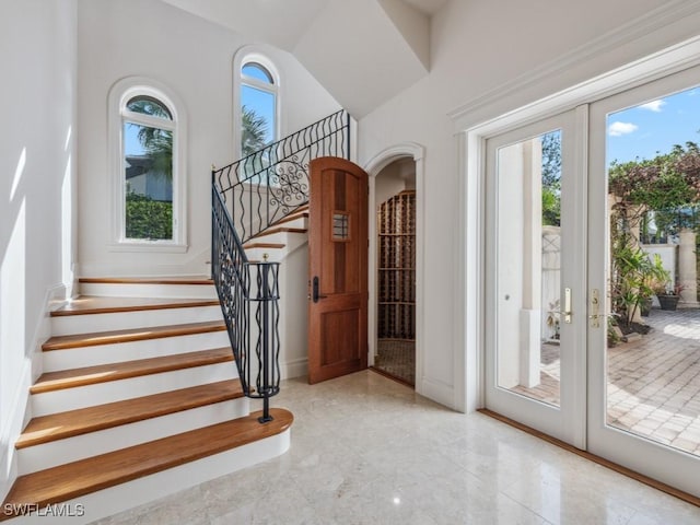 entryway featuring stairway and french doors