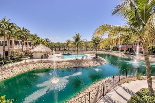 view of swimming pool with fence