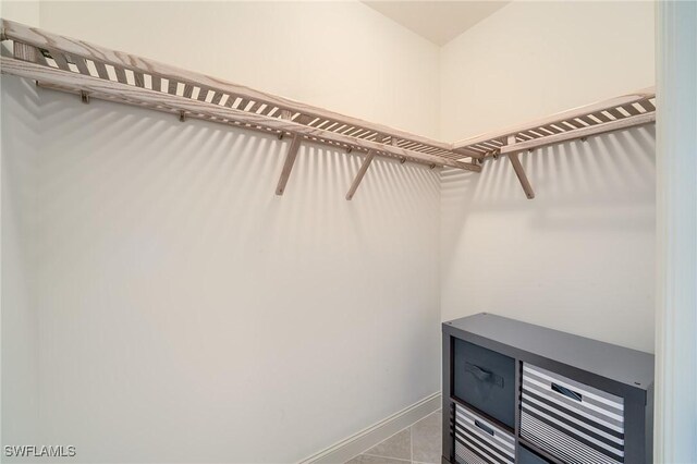 spacious closet featuring light tile patterned flooring