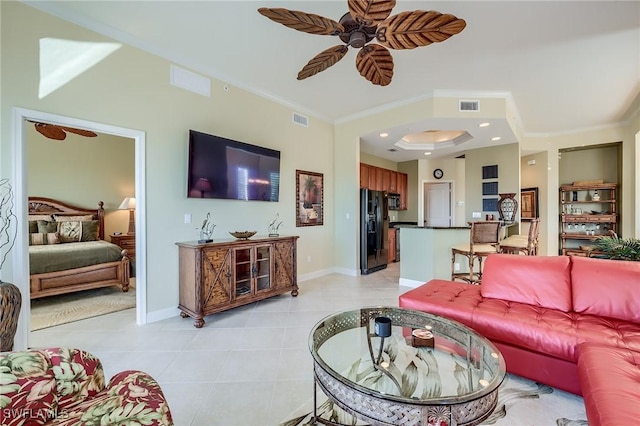 tiled living room with crown molding and ceiling fan