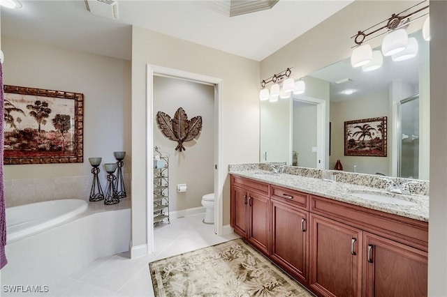 bathroom with tile patterned floors, vanity, a relaxing tiled tub, and toilet