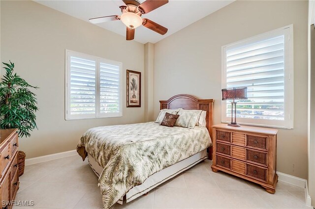 tiled bedroom featuring ceiling fan