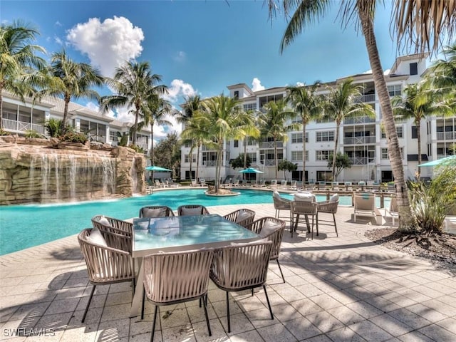 view of pool with pool water feature and a patio