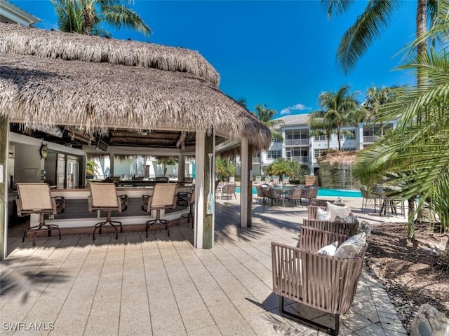 view of patio / terrace featuring outdoor dry bar and a gazebo