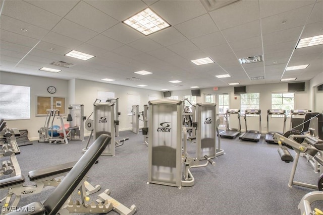 workout area featuring a paneled ceiling, baseboards, and visible vents