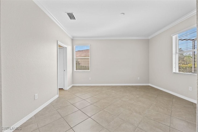 tiled empty room with crown molding and plenty of natural light