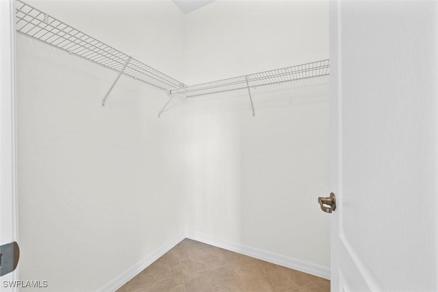 walk in closet featuring light tile patterned flooring