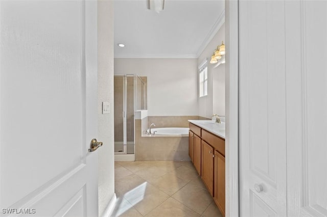 bathroom featuring separate shower and tub, tile patterned floors, vanity, and ornamental molding