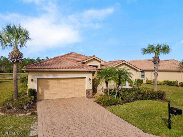 mediterranean / spanish house featuring a front yard and a garage