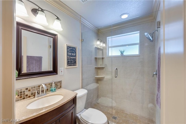 bathroom featuring vanity, toilet, ornamental molding, walk in shower, and tasteful backsplash