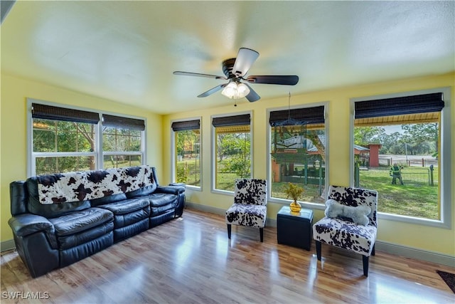 sunroom featuring ceiling fan and a healthy amount of sunlight