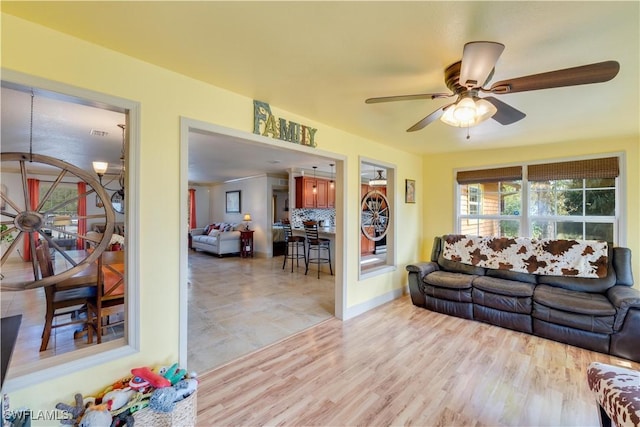 living room featuring light hardwood / wood-style floors and ceiling fan