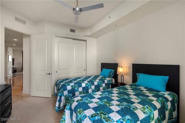 bedroom featuring light carpet, a closet, and ceiling fan