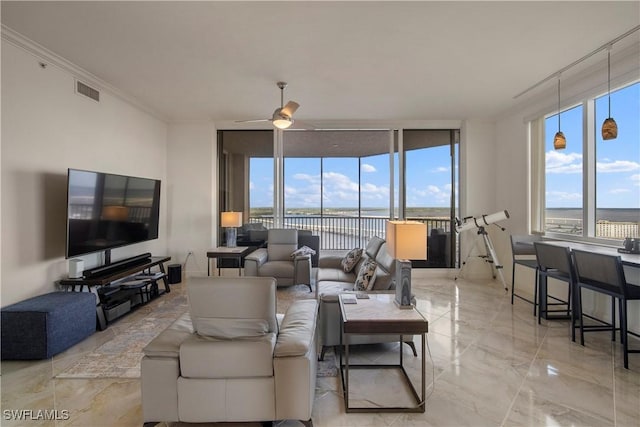 living room featuring ceiling fan, expansive windows, a water view, and ornamental molding