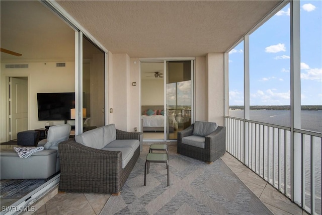 sunroom / solarium with a water view