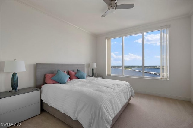 bedroom with ceiling fan, crown molding, a water view, and light colored carpet