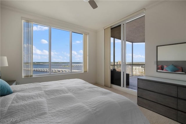 bedroom with access to outside, a water view, ceiling fan, and light colored carpet