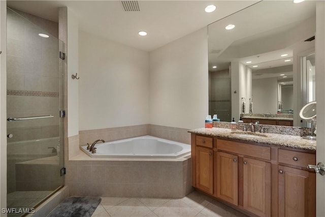 bathroom with tile patterned flooring, shower with separate bathtub, and vanity