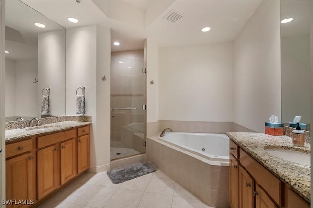 bathroom with tile patterned flooring, vanity, and shower with separate bathtub