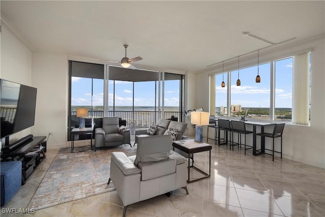 living room with ceiling fan, light tile patterned flooring, and a water view