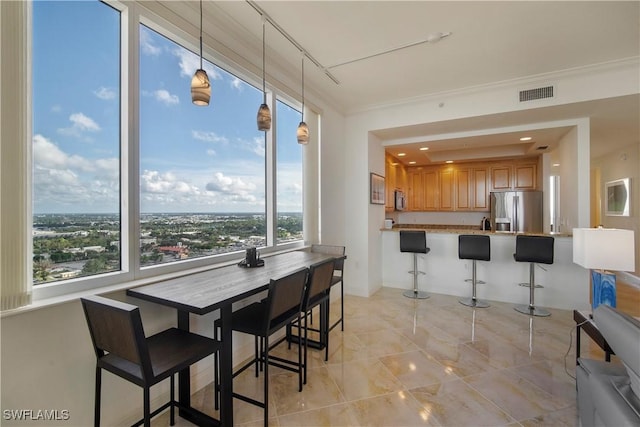 dining space with ornamental molding