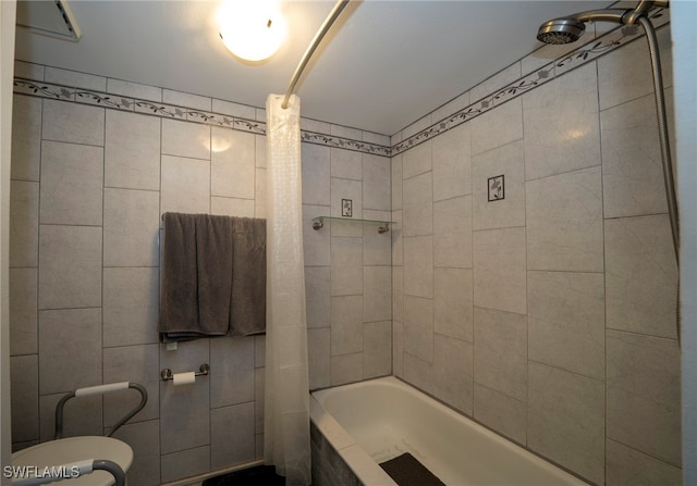 bathroom with shower / tub combo, toilet, and tile walls