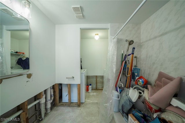 bathroom with concrete flooring and walk in shower