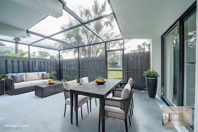 view of patio with an outdoor living space and glass enclosure