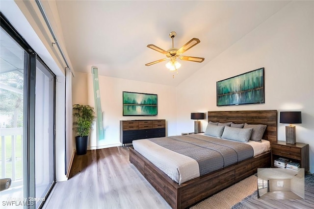 bedroom with ceiling fan, lofted ceiling, and light hardwood / wood-style floors