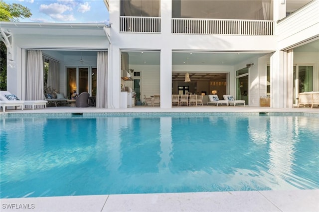 view of swimming pool featuring a patio and ceiling fan