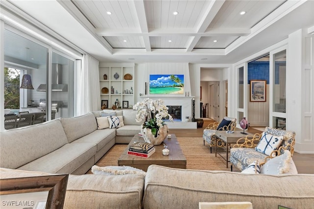 living room featuring hardwood / wood-style flooring, coffered ceiling, built in features, and beam ceiling