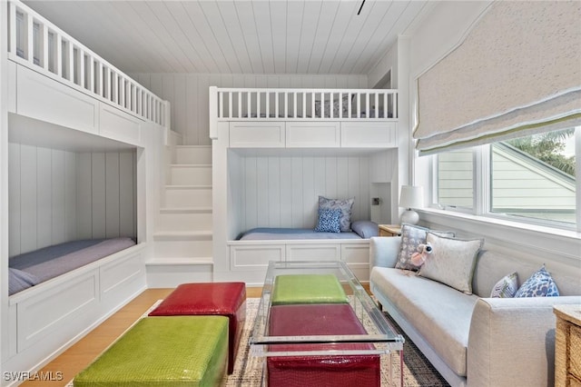 bedroom featuring light hardwood / wood-style flooring and wooden ceiling