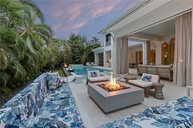 exterior space with a patio and an outdoor living space with a fire pit