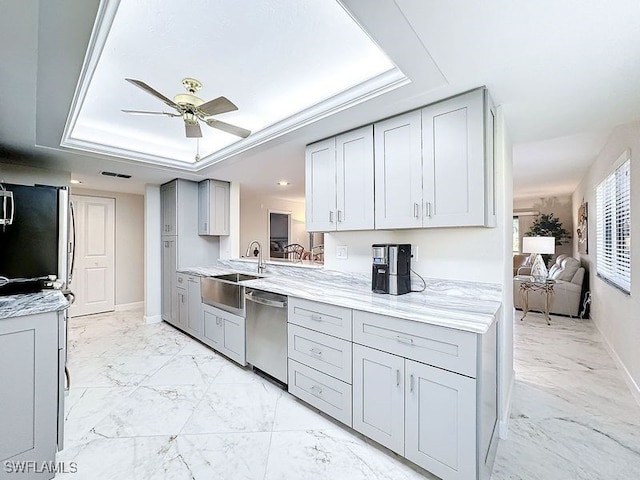 kitchen featuring gray cabinetry, ceiling fan, marble finish floor, stainless steel appliances, and a sink