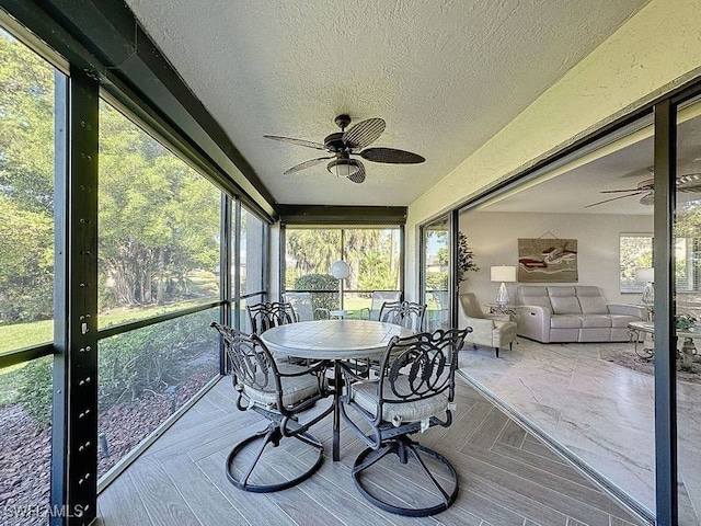 sunroom featuring a wealth of natural light and ceiling fan