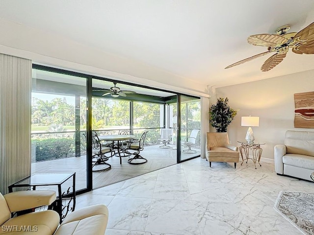 living room featuring ceiling fan and a healthy amount of sunlight