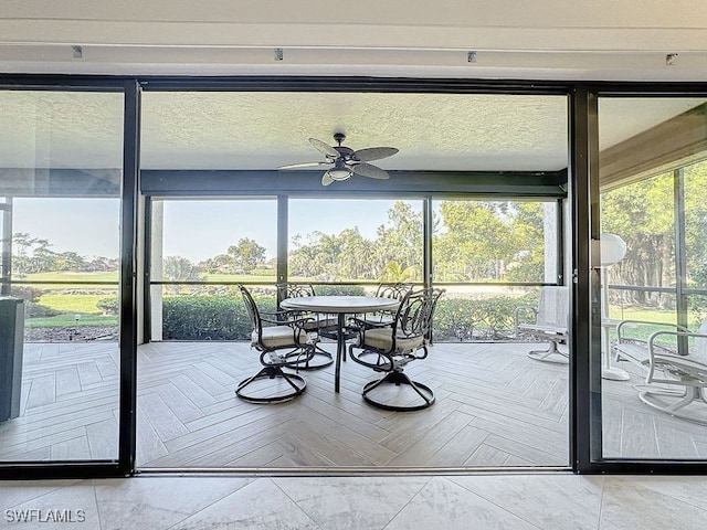 interior space with ceiling fan