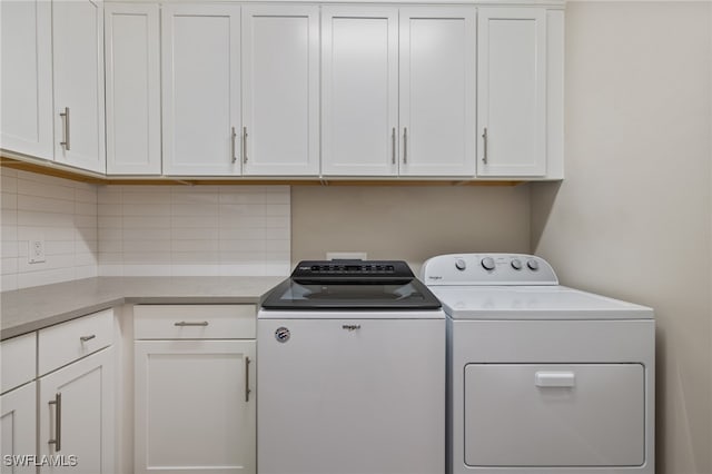 laundry room with cabinet space and washing machine and clothes dryer