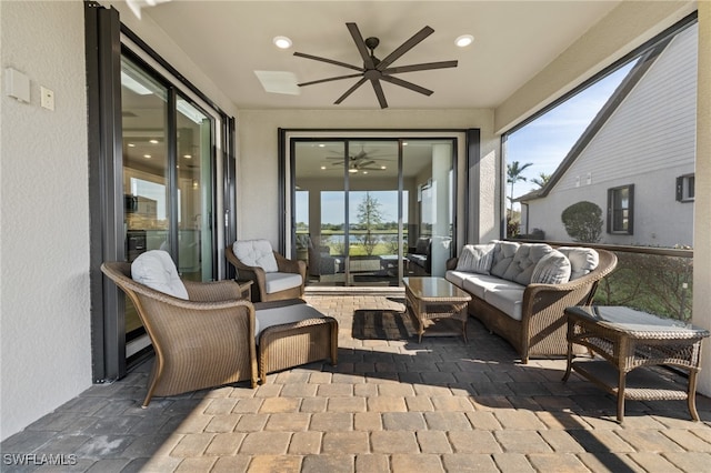 sunroom featuring a ceiling fan